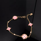 [Cyra] ARMBAND MIT STERN- UND SONNENMOTIV, ROSA PERLMUTT, ROSÉGOLD