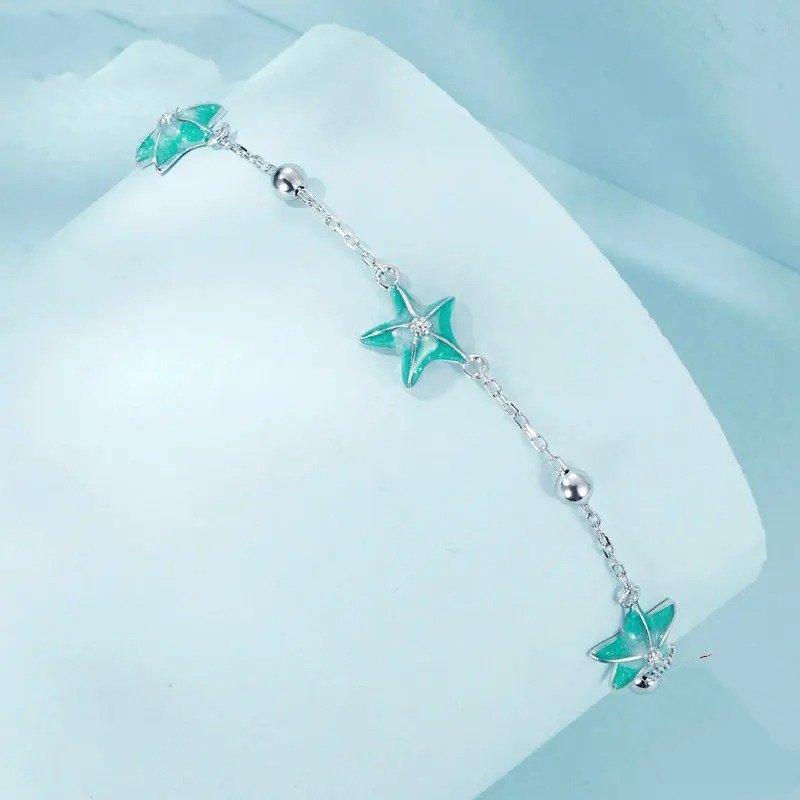 Gliederarmbänder mit blau-grünem Farbverlauf und Seestern-Motiv